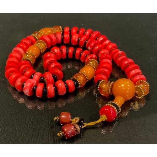 718 - A Tibetan coral and amber bead prayer marla necklace, composed of sixty pink coral disc, sixty four ... 