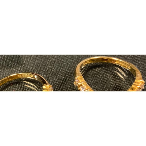 720 - A pair of diamond V rings, each inset with eleven round brilliant cut diamonds, total estimated diam... 