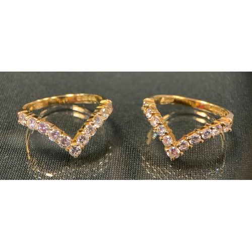 720 - A pair of diamond V rings, each inset with eleven round brilliant cut diamonds, total estimated diam... 