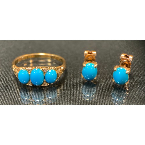 733 - A turquoise and diamond ring, set with three oval turquoise cabochons divided by diamond accents, un... 