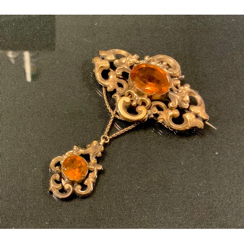 736 - A Victorian citrine and gilt metal metal pendant brooch, scrolling body and pendant droplet set with... 