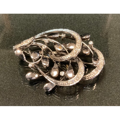 759 - A contemporary diamond and 18ct white gold brooch, arched multi-layer floral crest set with twenty t... 