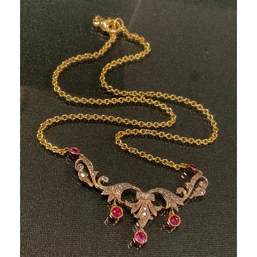 761 - An Edwardian diamond and ruby necklace, the scrolling floral body set with five vibrant red rubies a... 