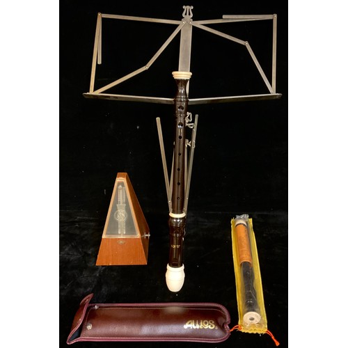 251 - A metronome; two Aulos recorders and a folding music stand