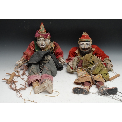 694 - A pair of Indonesian/Thai carved hardwood puppets, of Marionette type, traditionally dressed, 78cm l... 