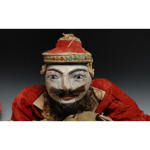 694 - A pair of Indonesian/Thai carved hardwood puppets, of Marionette type, traditionally dressed, 78cm l... 