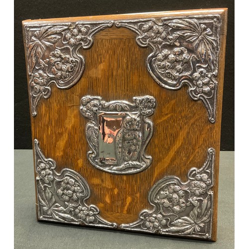 138 - An Art Nouveau silver mounted oak blotter, the fittings embossed with an owl, stylised flowers and s... 