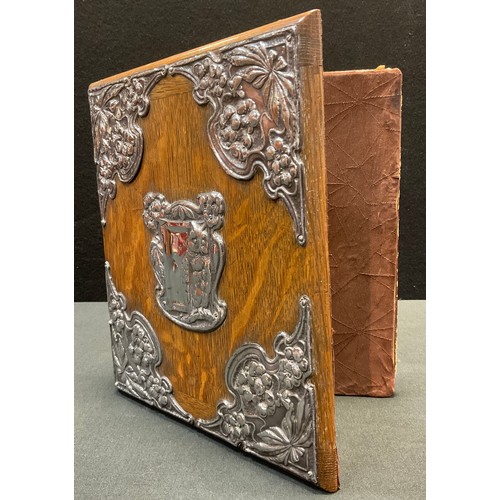 138 - An Art Nouveau silver mounted oak blotter, the fittings embossed with an owl, stylised flowers and s... 