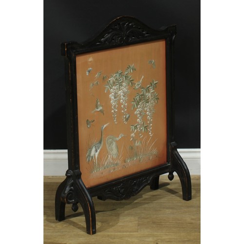 1338 - A late Victorian oak fire screen, the glazed banner with a Chinese silk panel worked on a peach grou... 