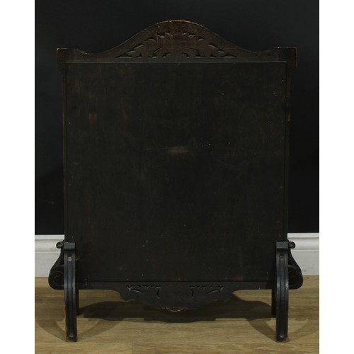 1338 - A late Victorian oak fire screen, the glazed banner with a Chinese silk panel worked on a peach grou... 