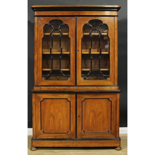 1005 - A 19th century walnut and ebonised library bookcase, moulded cornice above a pair of glazed doors, t... 