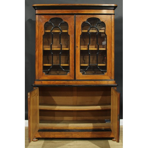 1005 - A 19th century walnut and ebonised library bookcase, moulded cornice above a pair of glazed doors, t... 