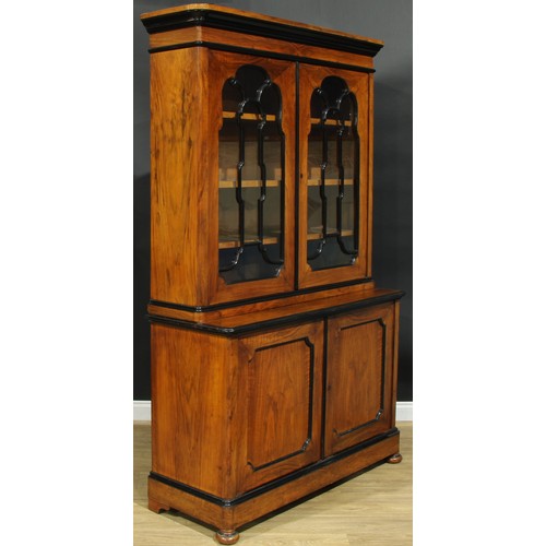 1005 - A 19th century walnut and ebonised library bookcase, moulded cornice above a pair of glazed doors, t... 