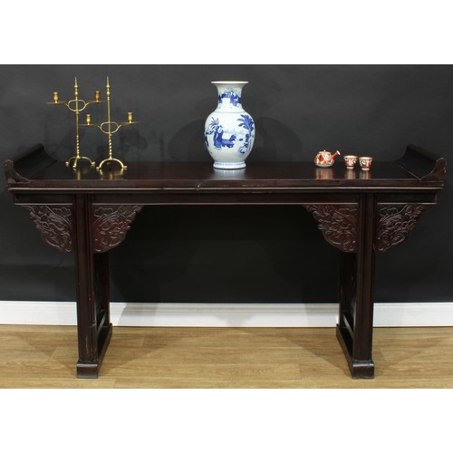 1019 - A Chinese altar table, rectangular top, shaped brackets moulded with leafy dragon heads, moulded leg... 