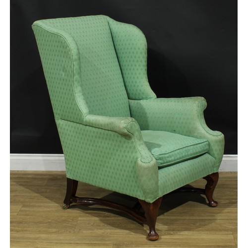 1088 - A George I Revival mahogany wingback armchair, stuffed-over upholstery, squab cushion, cabriole fore... 