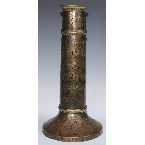 1191 - A pair of large Middle Eastern Islamic brass mosque candlesticks, pierced and engraved with a field ... 