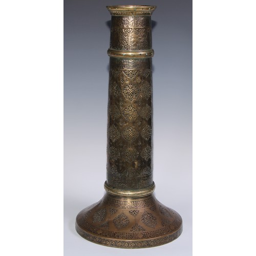 1191 - A pair of large Middle Eastern Islamic brass mosque candlesticks, pierced and engraved with a field ... 