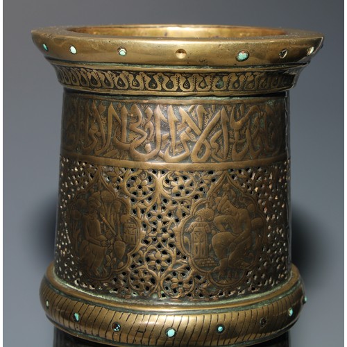 1191 - A pair of large Middle Eastern Islamic brass mosque candlesticks, pierced and engraved with a field ... 