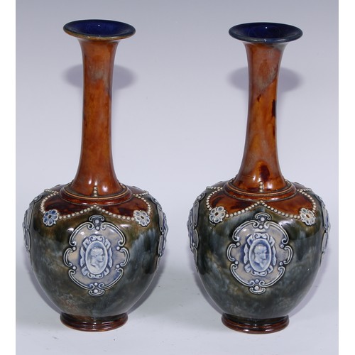 392 - A pair of Royal Doulton stoneware ovoid vases, sprigged with cameo portrait ovals on a mottled groun... 