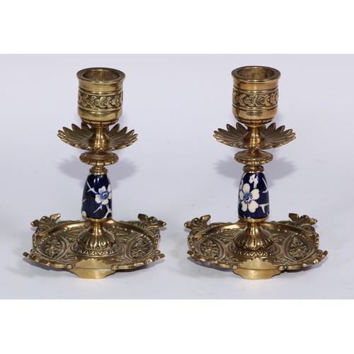 1391 - A pair of Aesthetic Movement gilt brass and earthenware candlesticks, cast and decorated in the Japa... 