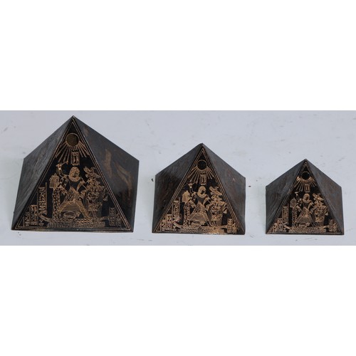 1145 - An Art Deco Egyptian Revival graduated trio of desk models, pyramids, the largest 4cm high