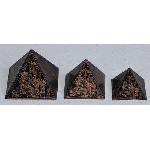 1145 - An Art Deco Egyptian Revival graduated trio of desk models, pyramids, the largest 4cm high