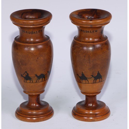 1194 - A pair of Middle Eastern turned olive wood specimen vases, each decorated with camels, 15cm high, in... 