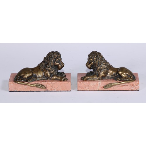 1462 - French School, 19th century, a pair of bronzes, recumbent lions, facing to dexter and sinister, marb... 