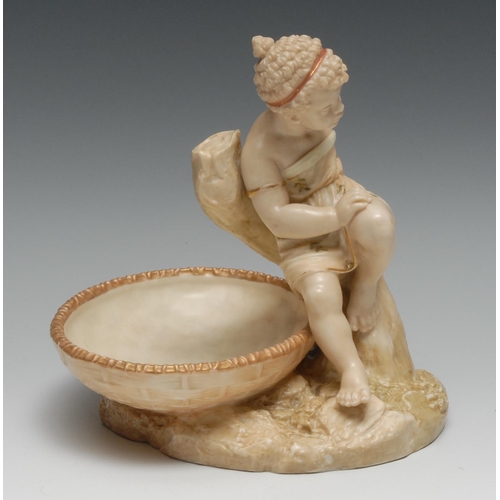 423 - A Royal Worcester Hadley figural bowl, Africa, seated on an oval basket, 19.5cm high, printed crown ... 