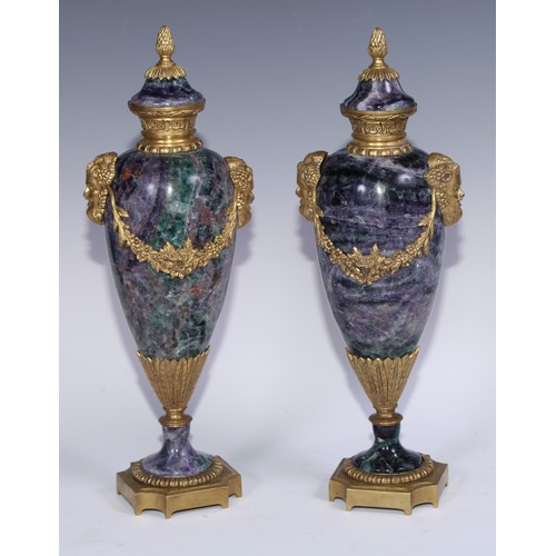 1193 - A pair of Louis XVI Revival gilt metal mounted fluorspar slender ovoid mantel urns, pineapple finals... 