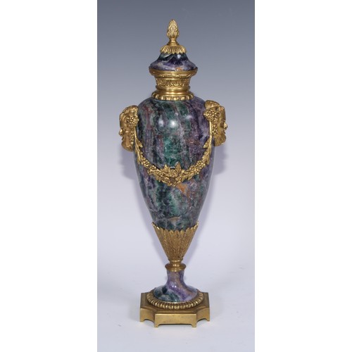 1193 - A pair of Louis XVI Revival gilt metal mounted fluorspar slender ovoid mantel urns, pineapple finals... 