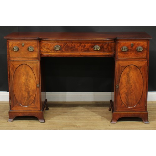 914 - A 19th century mahogany breakfront sideboard, slightly oversailing top with reeded edge above three ... 