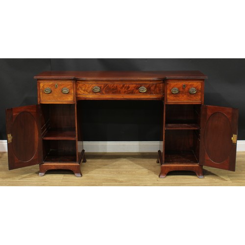 914 - A 19th century mahogany breakfront sideboard, slightly oversailing top with reeded edge above three ... 