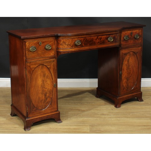 914 - A 19th century mahogany breakfront sideboard, slightly oversailing top with reeded edge above three ... 