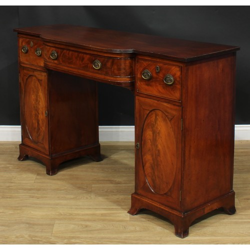 914 - A 19th century mahogany breakfront sideboard, slightly oversailing top with reeded edge above three ... 