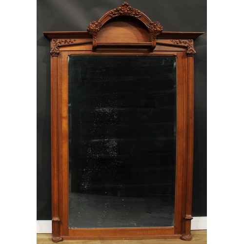 1447 - A substantial Art Nouveau oak chimney glass, moulded pediment with domed niche carved and applied wi... 