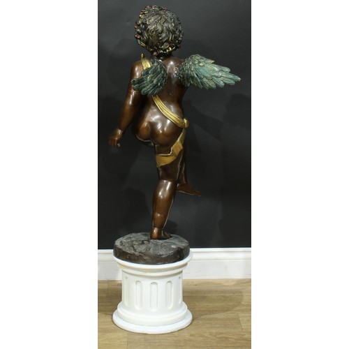 918 - Continental School, a brown patinated and cold painted bronze, of an amorini, 85cm high, marble plin... 