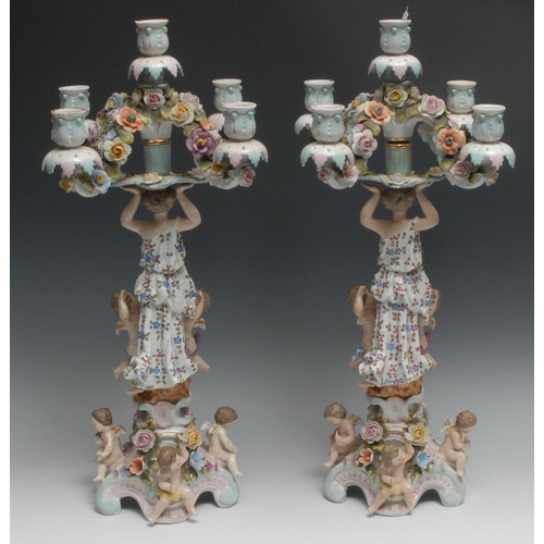 529 - A pair of Continental figural five-light, four-branch candelabra, the columns with bare footed maide... 