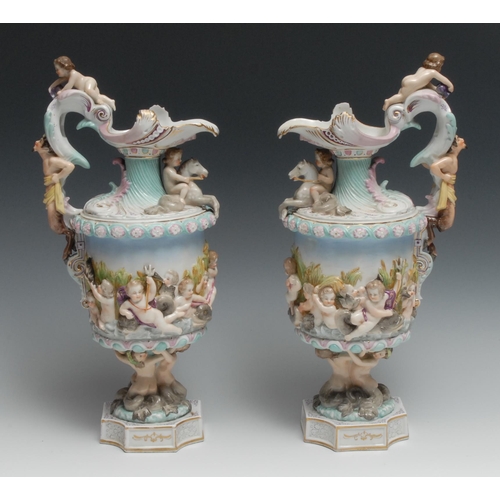 532 - A pair of Naples porcelain ewers, moulded in relief with putto and mythical beasts, 37.5cm high, c.1... 