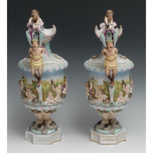 532 - A pair of Naples porcelain ewers, moulded in relief with putto and mythical beasts, 37.5cm high, c.1... 