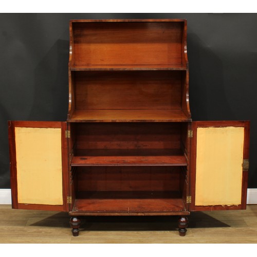 1437 - A Regency mahogany waterfall bookcase cabinet, shaped superstructure above a pair of doors enclosing... 