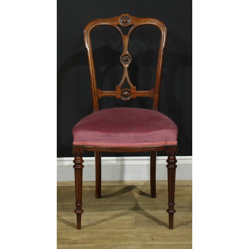 1123 - A set of four late Victorian walnut drawing room side chairs, each cresting rail, splat and bar carv... 