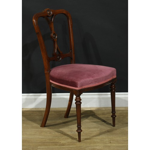 1123 - A set of four late Victorian walnut drawing room side chairs, each cresting rail, splat and bar carv... 