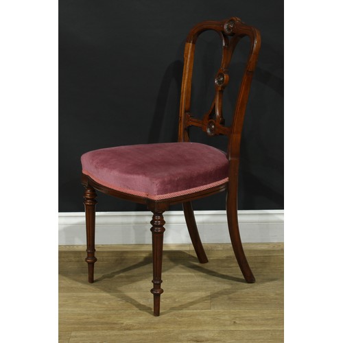 1123 - A set of four late Victorian walnut drawing room side chairs, each cresting rail, splat and bar carv... 