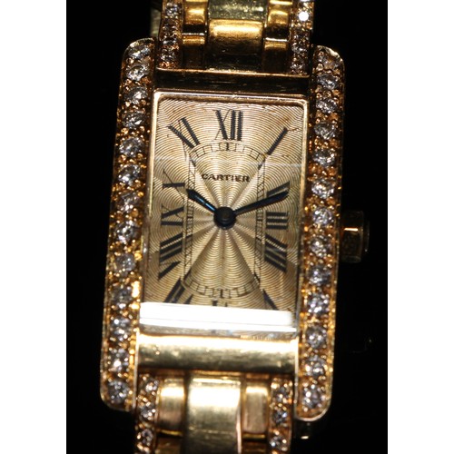 331 - A lady's 18ct gold and diamond Cartier watch, champagne dial with Roman numerals, the case 35mm x 20... 