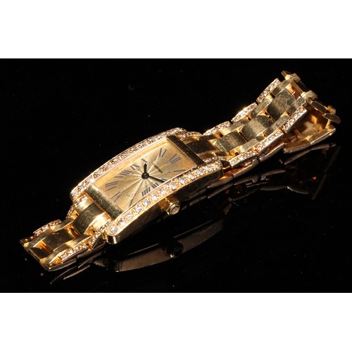 331 - A lady's 18ct gold and diamond Cartier watch, champagne dial with Roman numerals, the case 35mm x 20... 