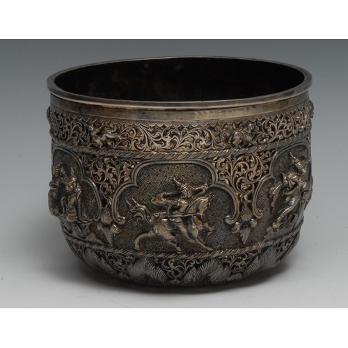 81 - A Burmese silver bowl, of double-walled construction, the outer pierced and chased with animals and ... 