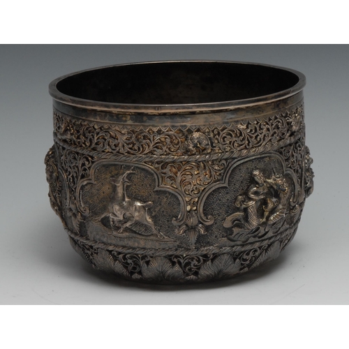 81 - A Burmese silver bowl, of double-walled construction, the outer pierced and chased with animals and ... 