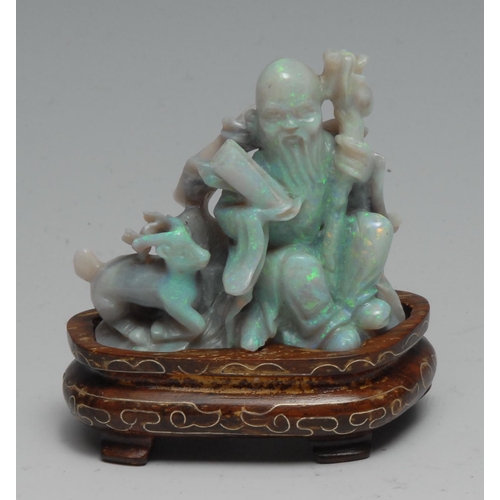 761 - A Chinese carved opal figure group, Shou Lao and deer, inlaid hardwood stand, 7cm high overall