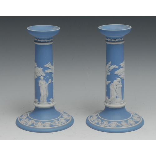 448 - A pair of Wedgwood jasperware candlesticks, typically sprigged in the Neo-Classical taste, 20.5cm hi... 